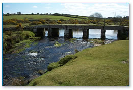 Ancient granite bridge on De Lank River, evidence of overgrazing on the bankside